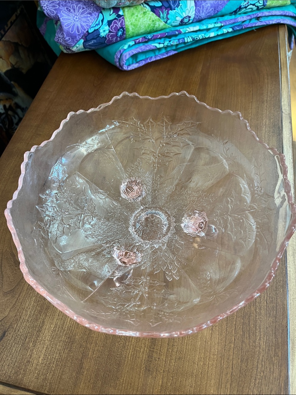 Vintage Fenton pink glass footed bowl, likely in the "Stag and Holly" pattern.
